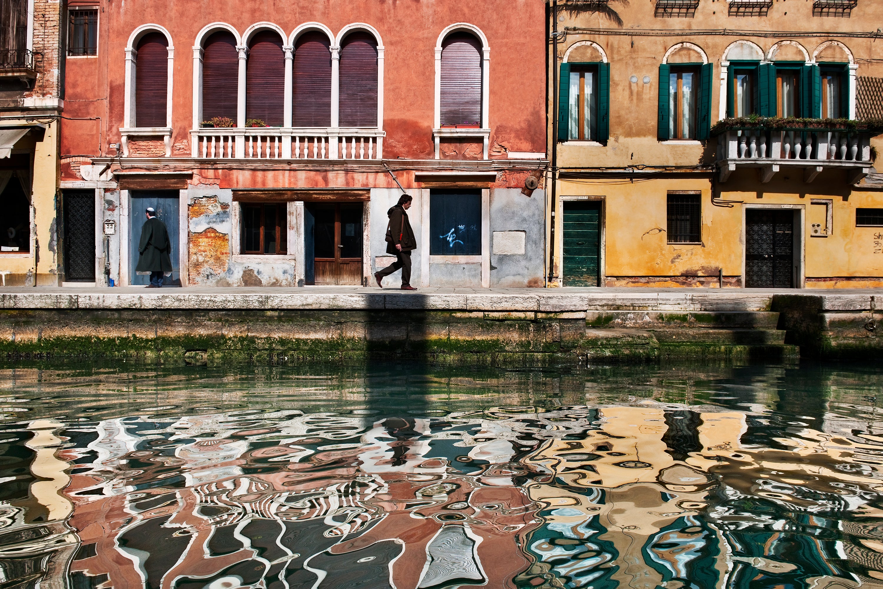 Man walks along canal Venice — Steve McCurry